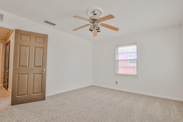 carpeted empty room featuring ceiling fan