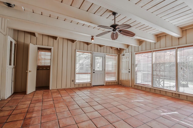 unfurnished sunroom with beam ceiling and ceiling fan