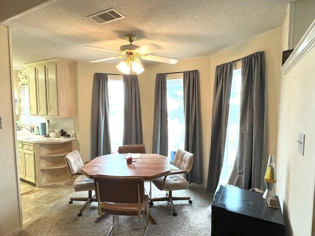 dining room featuring ceiling fan and a textured ceiling