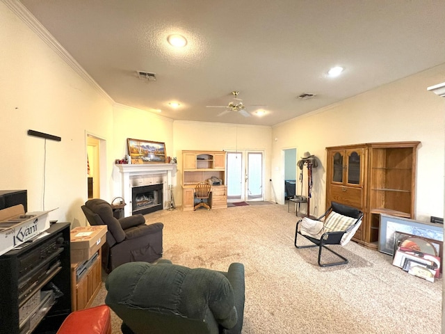 living room featuring carpet floors, ornamental molding, and ceiling fan