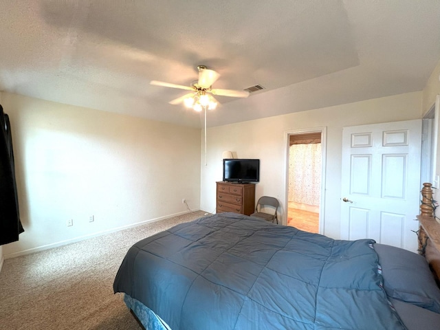 carpeted bedroom featuring connected bathroom, a textured ceiling, and ceiling fan