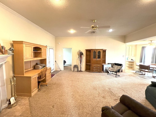 carpeted living room featuring crown molding, built in desk, and ceiling fan