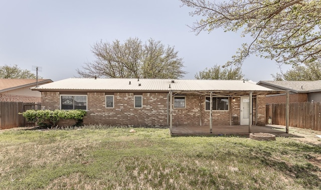 back of property with a yard and a patio area