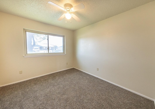 empty room with ceiling fan, carpet, and a textured ceiling