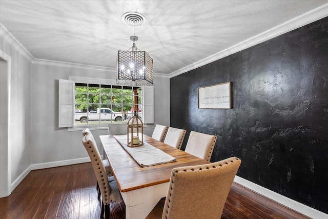 dining space with crown molding, dark hardwood / wood-style floors, and an inviting chandelier