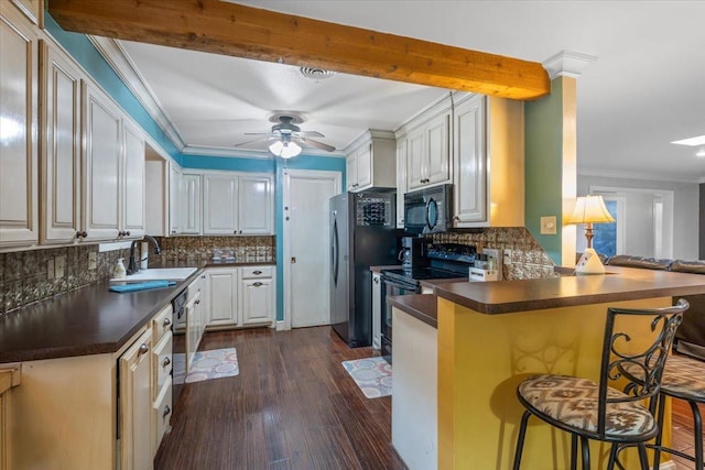 kitchen with sink, a kitchen breakfast bar, kitchen peninsula, decorative backsplash, and black appliances