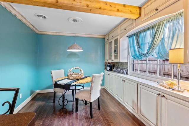 dining space with dark hardwood / wood-style flooring, ornamental molding, and beamed ceiling