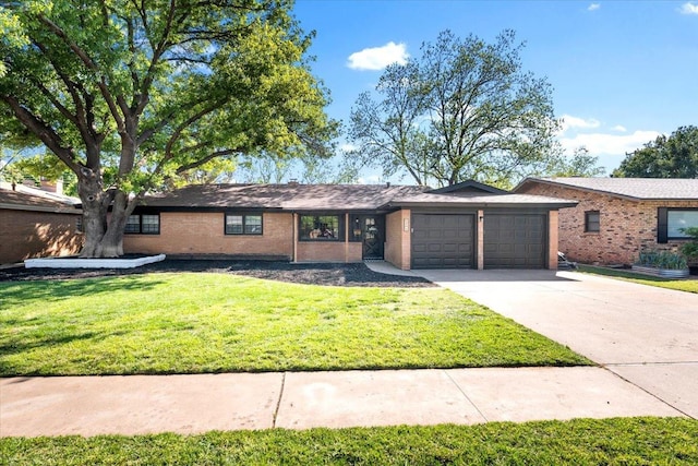 ranch-style home with a garage and a front lawn