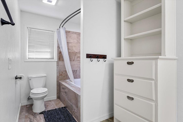 bathroom featuring toilet and shower / bath combo