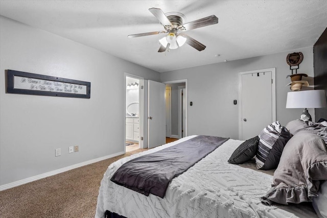 bedroom with ensuite bathroom, carpet flooring, and ceiling fan