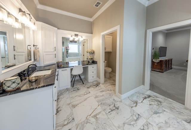 bathroom with marble finish floor, ornamental molding, visible vents, and baseboards