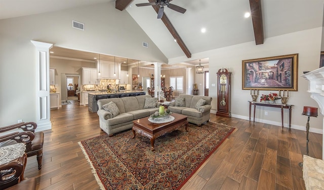 living area featuring visible vents, dark wood-type flooring, high vaulted ceiling, beamed ceiling, and ornate columns