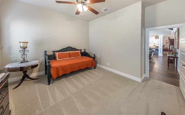 carpeted bedroom with baseboards, visible vents, and ceiling fan