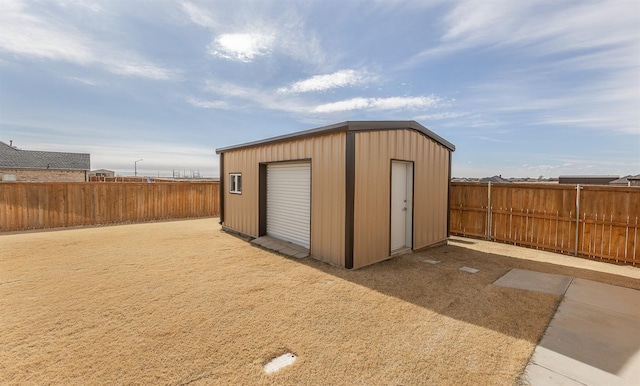 view of outdoor structure with a fenced backyard and an outdoor structure