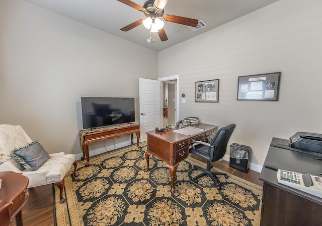 home office featuring ceiling fan, wood finished floors, visible vents, and baseboards