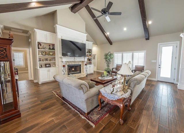 living room featuring ceiling fan, dark wood-style flooring, beamed ceiling, a fireplace, and high vaulted ceiling