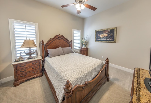 bedroom with baseboards, a ceiling fan, and light colored carpet