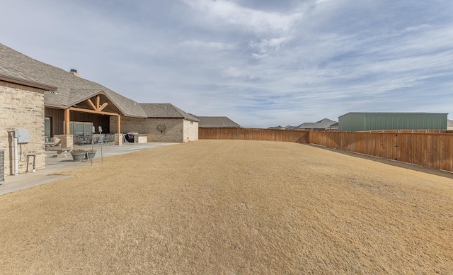 view of yard with a patio area and a fenced backyard