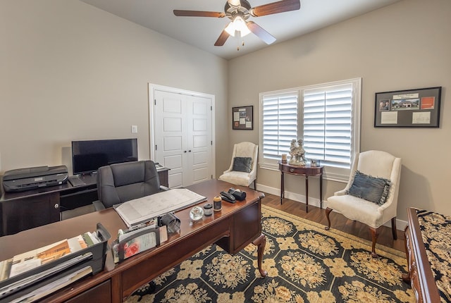 office area featuring baseboards, a ceiling fan, and wood finished floors