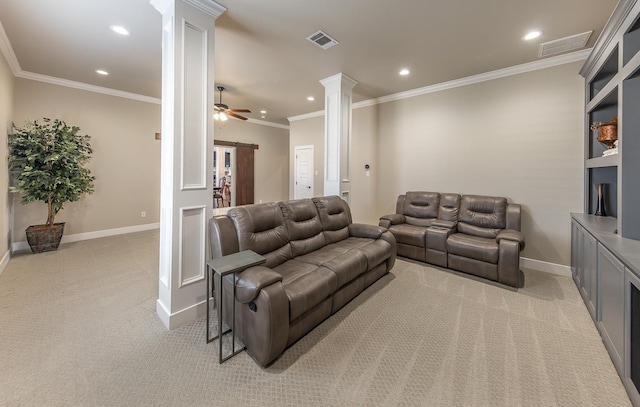 living area with visible vents, a barn door, light carpet, and decorative columns