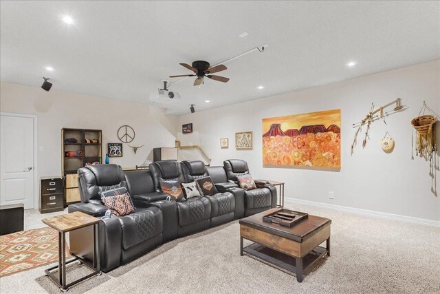 carpeted cinema room with ceiling fan