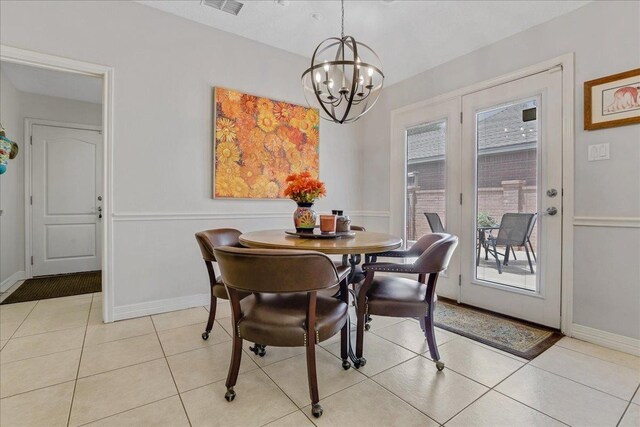 tiled dining room featuring a notable chandelier