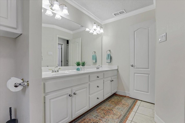 bathroom featuring tile patterned flooring, vanity, crown molding, and a textured ceiling