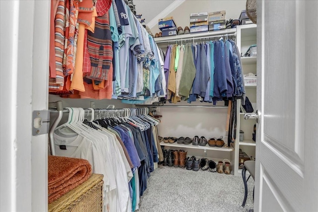 spacious closet with vaulted ceiling and carpet flooring