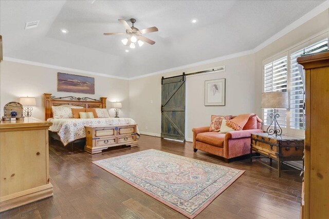 bedroom featuring dark wood-type flooring, ornamental molding, a barn door, and a raised ceiling