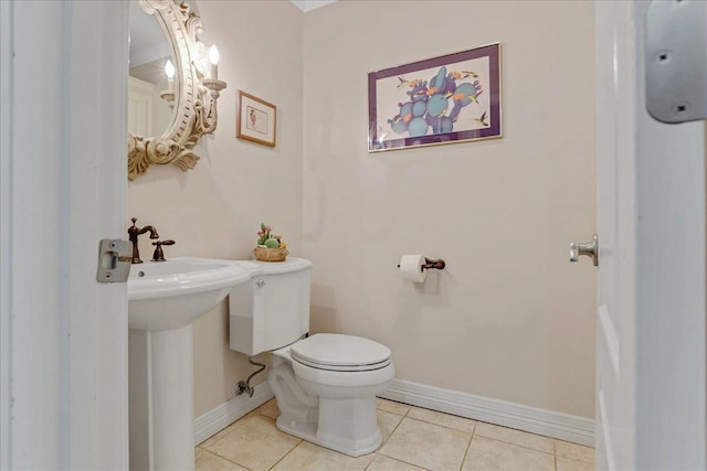 bathroom featuring tile patterned flooring, sink, and toilet