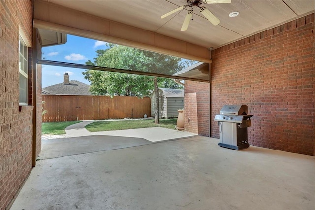 view of patio featuring a grill, ceiling fan, and a storage shed