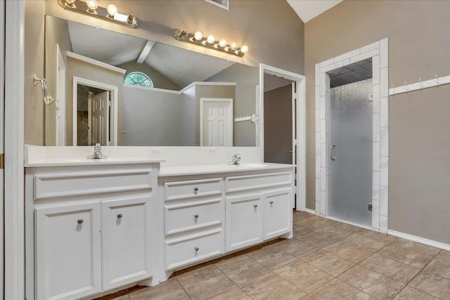 bathroom featuring vanity, an enclosed shower, and vaulted ceiling