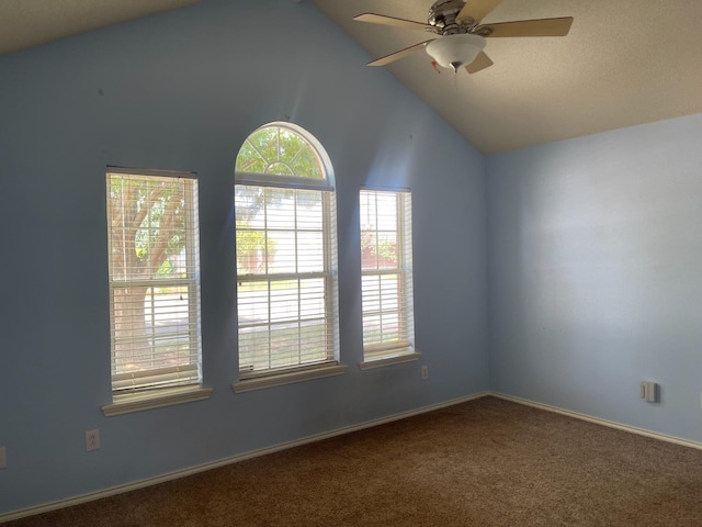 carpeted spare room featuring lofted ceiling and ceiling fan