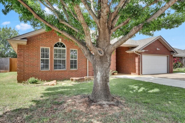 view of front of house featuring a garage and a front lawn