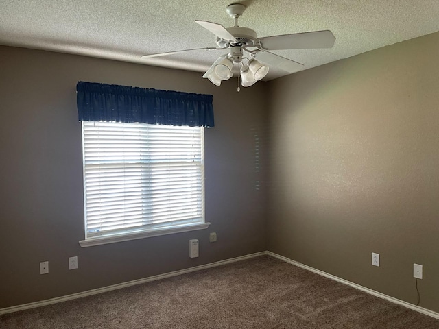 carpeted spare room with ceiling fan and a textured ceiling