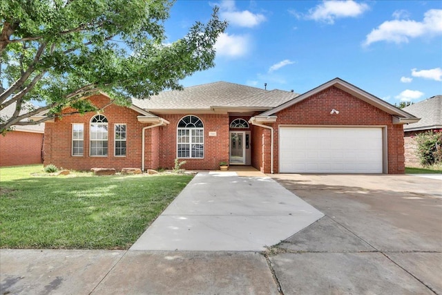 ranch-style house with a garage and a front lawn