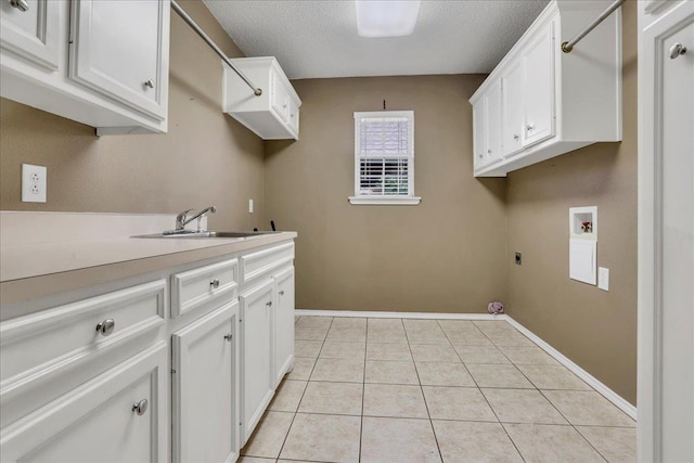 laundry area featuring light tile patterned flooring, sink, cabinets, hookup for a washing machine, and hookup for an electric dryer