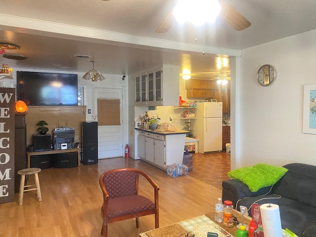 living room with ceiling fan and light hardwood / wood-style flooring