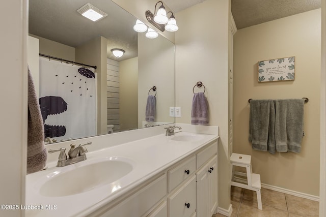 1310 Yorkshire Ave, Wolfforth, TX 79382 - full bath with double vanity, a sink, baseboards, and tile patterned floors