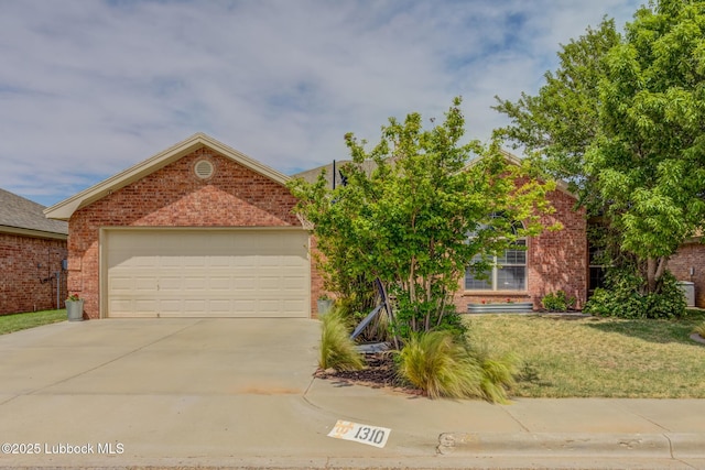 1310 Yorkshire Ave, Wolfforth, TX 79382 - view of front of home with an attached garage, driveway, a front lawn, and brick siding
