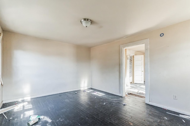 empty room with dark hardwood / wood-style flooring