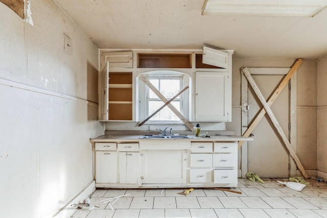 kitchen with white cabinetry and sink