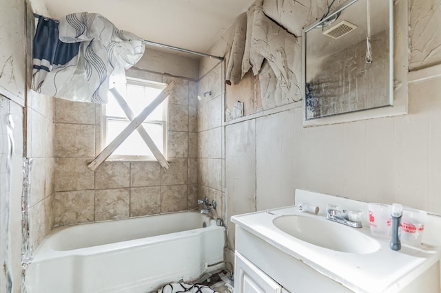 bathroom with vanity and tiled shower / bath