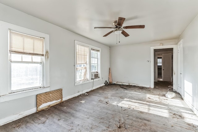 unfurnished room featuring cooling unit and ceiling fan