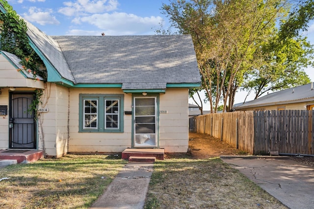 view of exterior entry with a yard