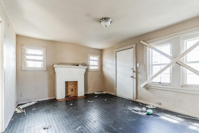 unfurnished living room featuring a fireplace and dark hardwood / wood-style flooring