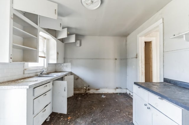 kitchen with white cabinetry and sink