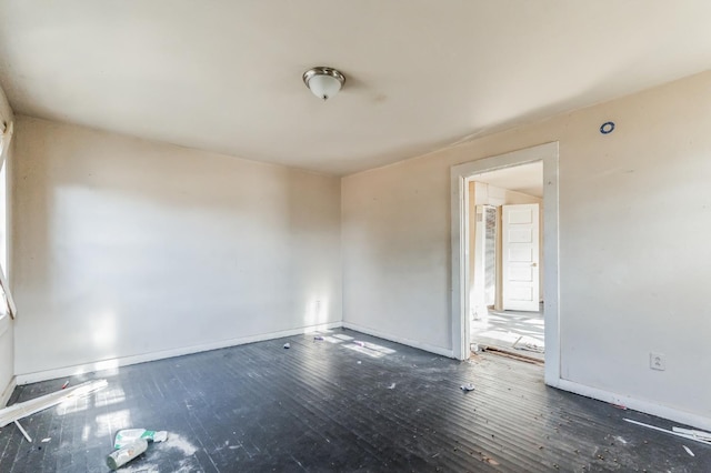 spare room featuring dark hardwood / wood-style flooring