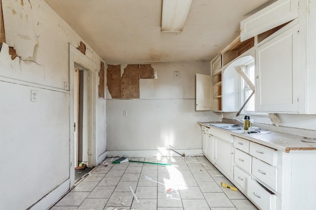 kitchen featuring sink and white cabinets