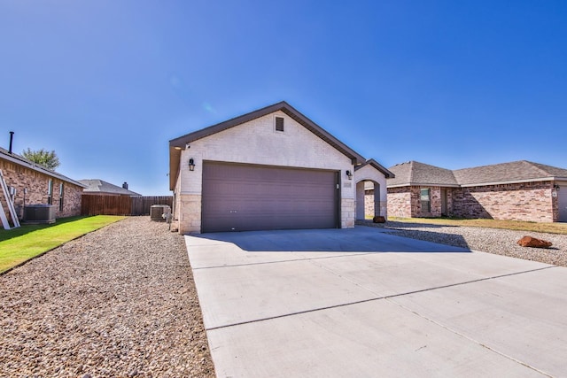 view of front of home featuring a garage and central AC unit